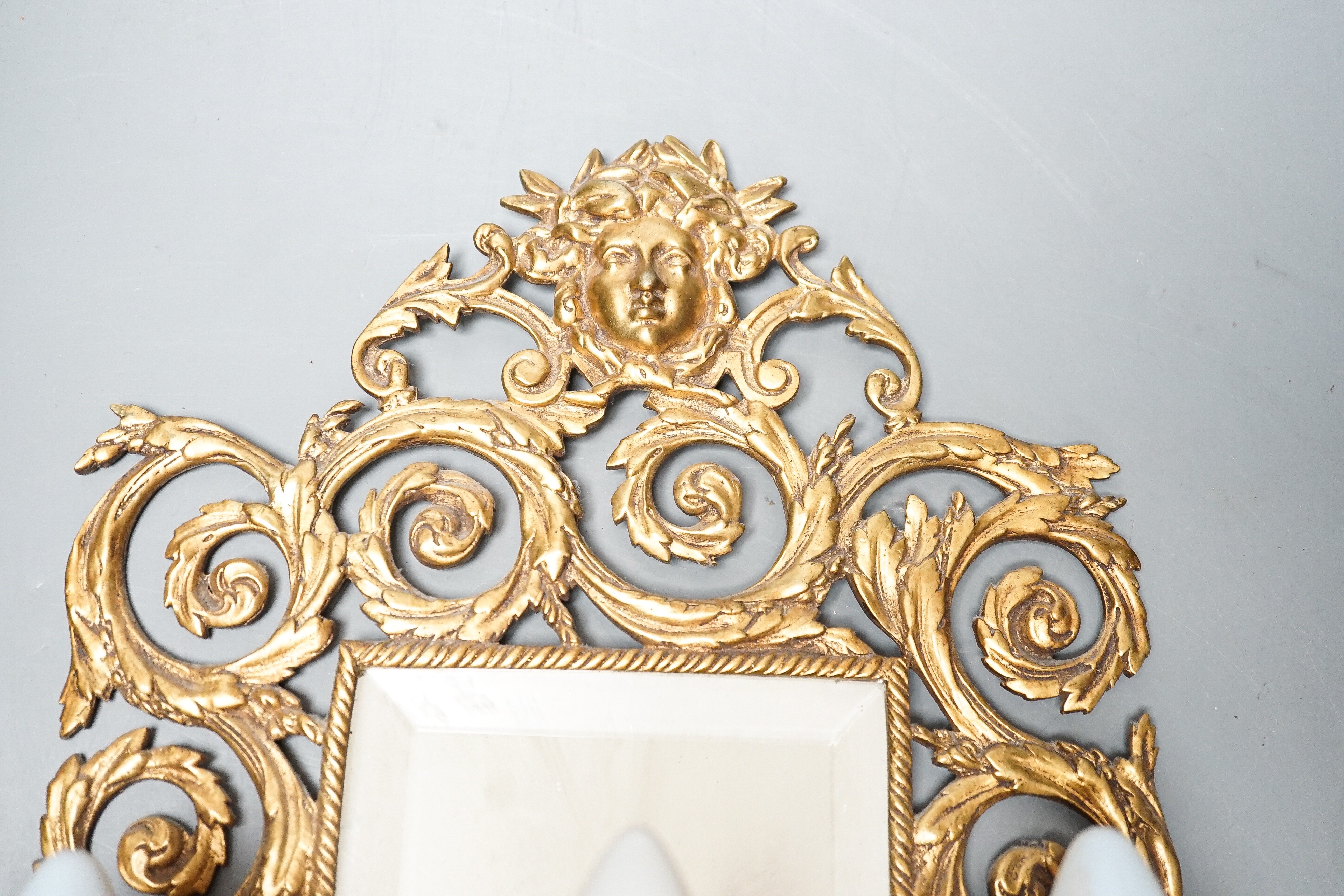 A pair of early 20th century gilt brass girandole mirrors, 39cms high.